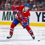 Lane Hutson, numéro 48 du Canadien, en chandail rouge, en possession de la rondelle
