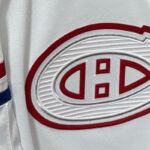 Gros plan du logo du Canadien sur le chandail blanc Hometown Remix